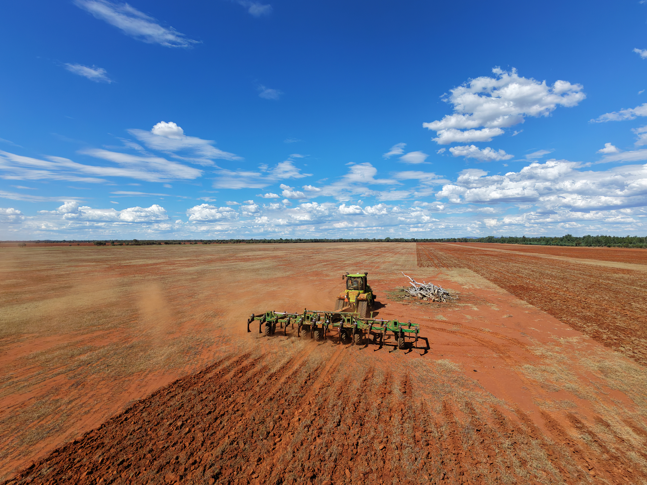 Front aerial view of a tractor pulling a K-Line Ag UltraRipper across a red-soil paddock at Mount Hope