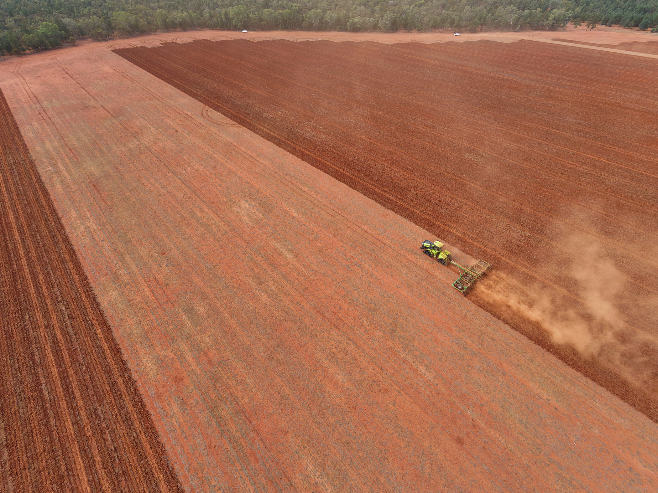 High aerial view of a tractor and K-Line Ag UltraRipper working across a large red-soil paddock at Mount Hope