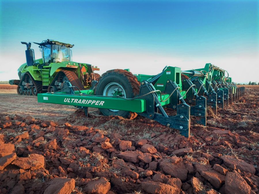 Close view of a K-Line Ag UltraRipper in red soil at Mount Hope with a tracked tractor behind